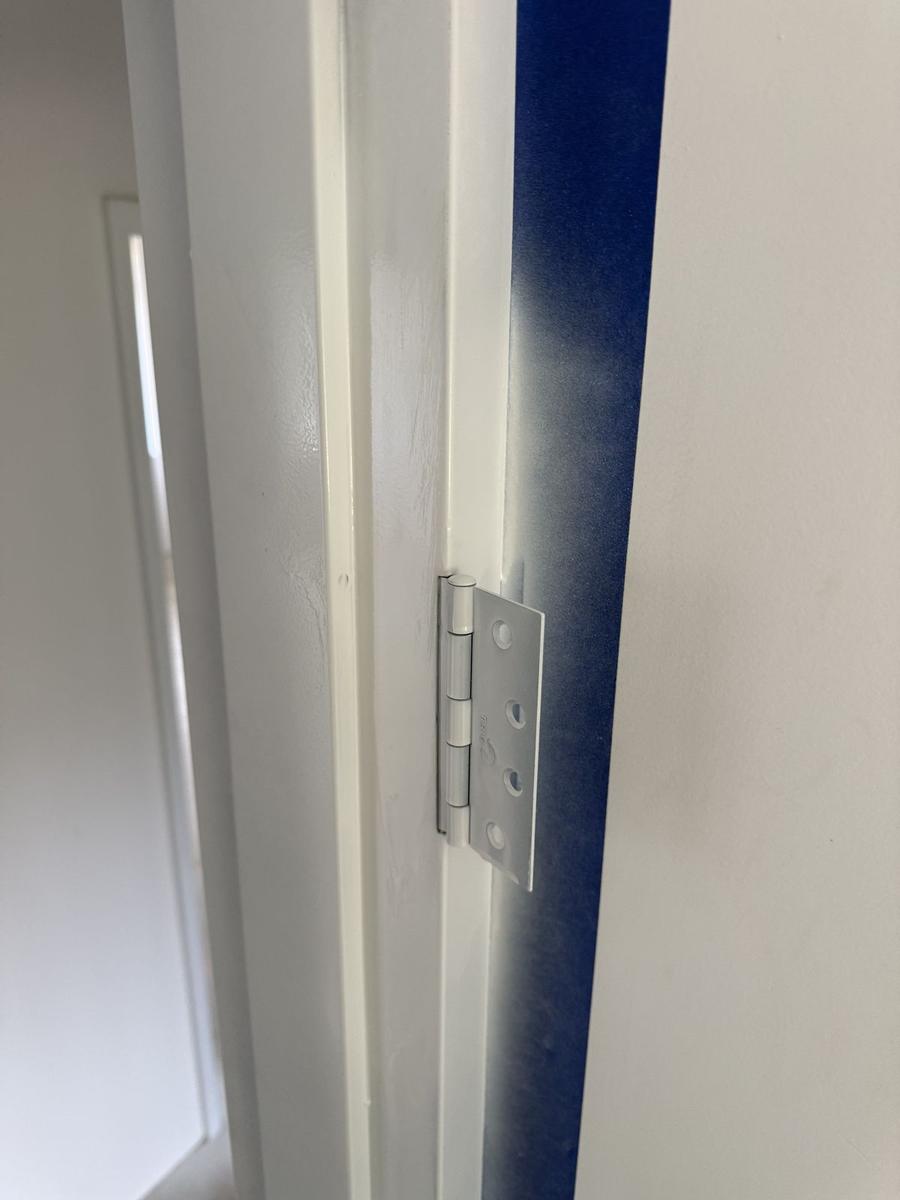 Hinge fitted to a frame masked for painting